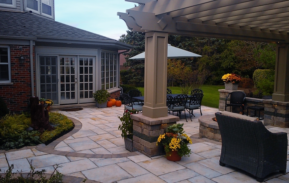 Backyard-two-tier-patio-pergola-outdoor-dining-Unilock-brick-Pouls-Landscaping   